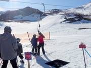 Children are assisted when getting on the drag lift.