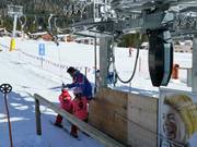 The staff assists with getting on the platter lift.