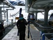 The staff load the skis into the gondola.