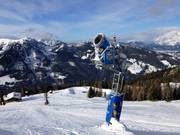Snowmaking tower with storage pond