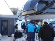 Friendly staff assist you when boarding the chairlift.