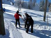 The staff assists with boarding the drag lift.