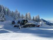 A snow groomer on standby
