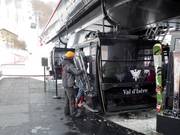 The staff assists with boarding the gondola lift.