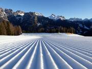 Wide and perfectly groomed slope in the Civetta ski area